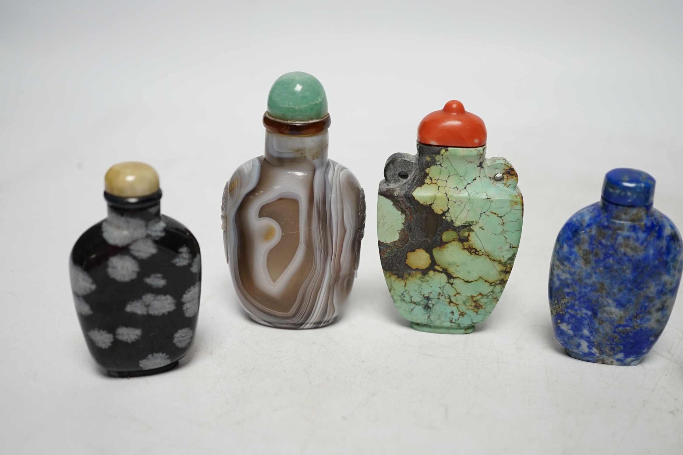 Five Chinese hardstone snuff bottles, 19th/20th century to include: black and grey marble, malachite, turquoise matrix, lapis lazuli and banded agate, largest 7.5cm high